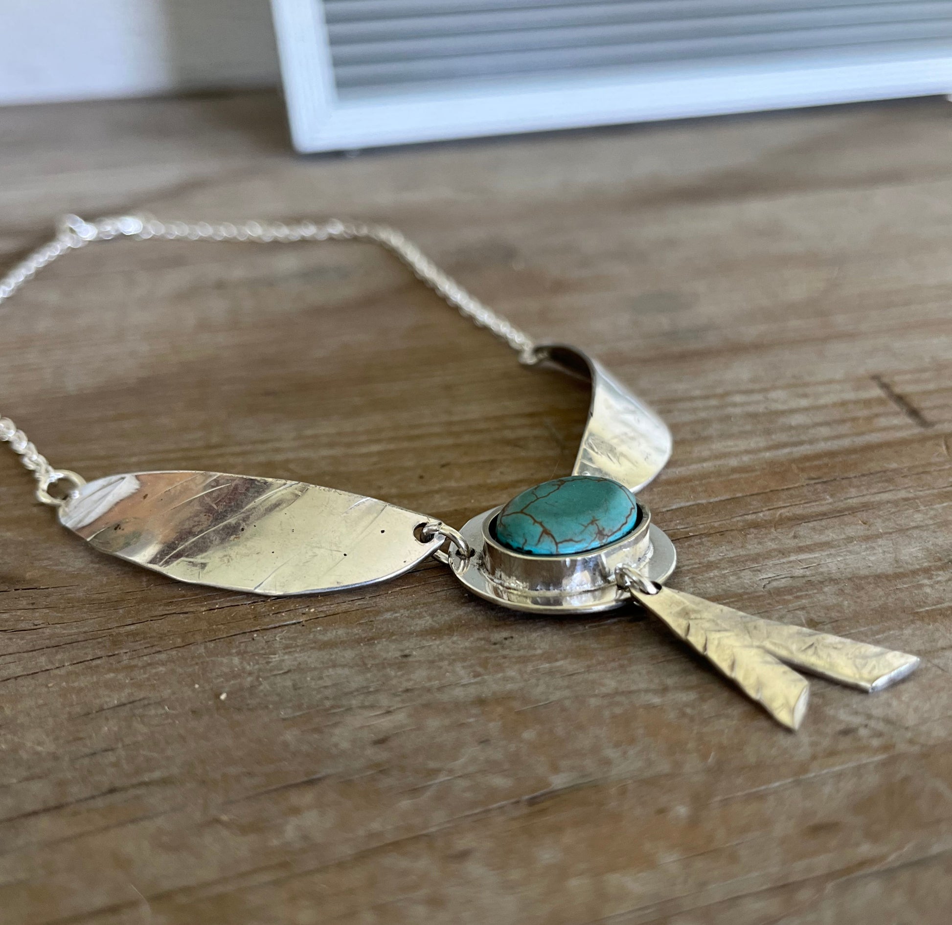 Close-up of Native Wings spoon pendant with stone bead - eco-friendly upcycled jewelry