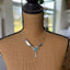 Handcrafted Native American style necklace with fork tine feathers and turquoise colored stone