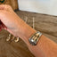 BADASS hand-stamped spoon cuff bracelet shown on model wrist - vintage 1923 Bride pattern silverplate with empowering message
