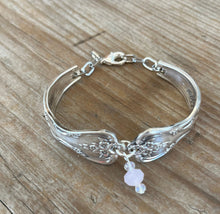Top down view on spoon bracelet with pink beads