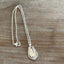 Close-up of Pearl Fenwick silverplate spoon pendant showing dots and swooshes pattern detail, handpolished vintage silverware necklace