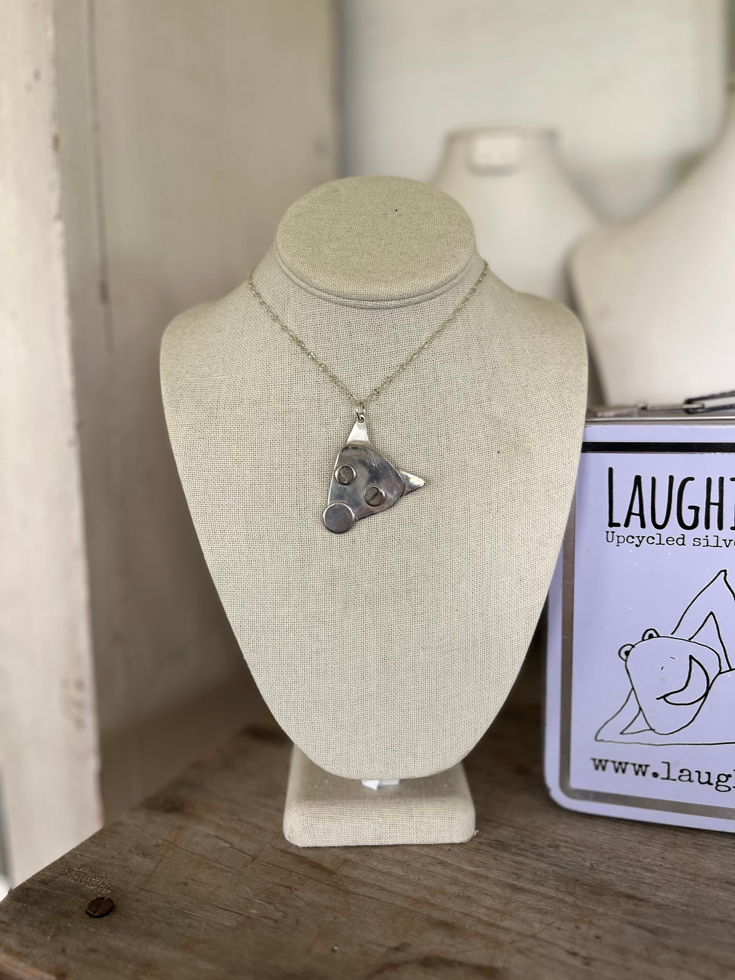 Mojo spoon puppy head necklace shown on jewelry bust, sustainable handmade dog lover gift jewelry from upcycled silverplate