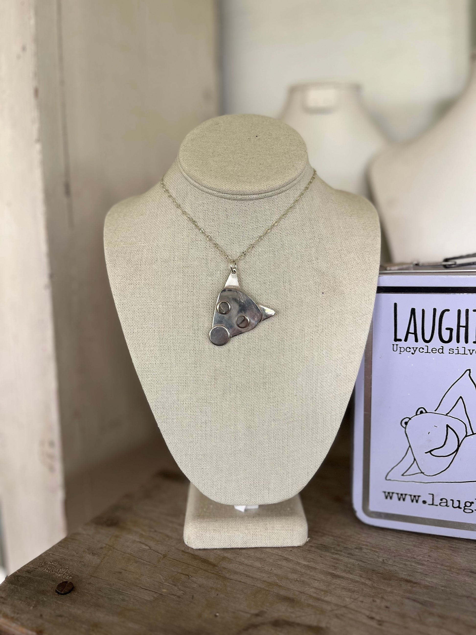 Mojo spoon puppy head necklace shown on jewelry bust, sustainable handmade dog lover gift jewelry from upcycled silverplate