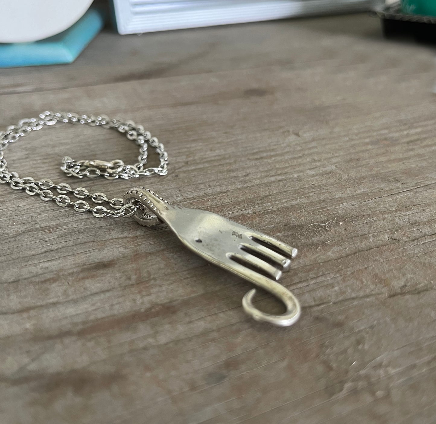Close-up of fork elephant necklace showing hand-stamped details, vintage silverplate patina and chunky chain