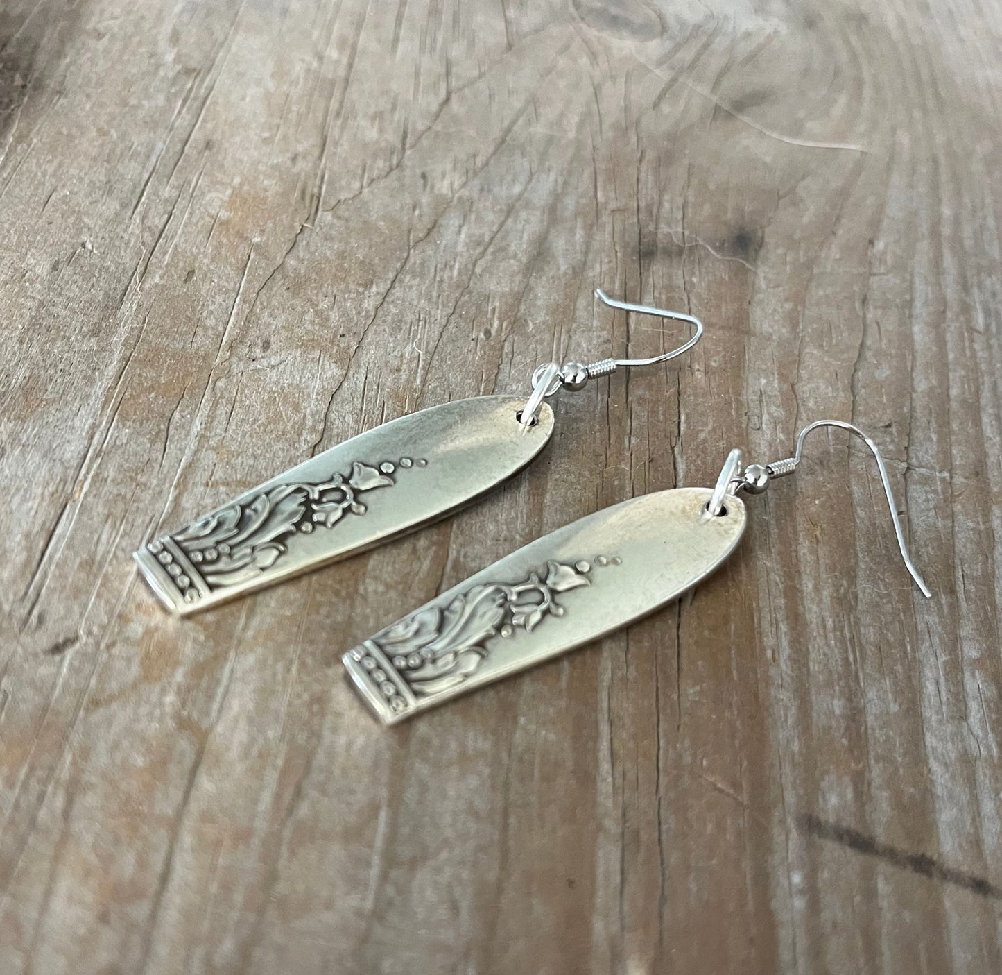 Close-up detail of Galanthus Nivalis snow drop flower design on vintage spoon handle earrings, one-of-a-kind 1940s pattern