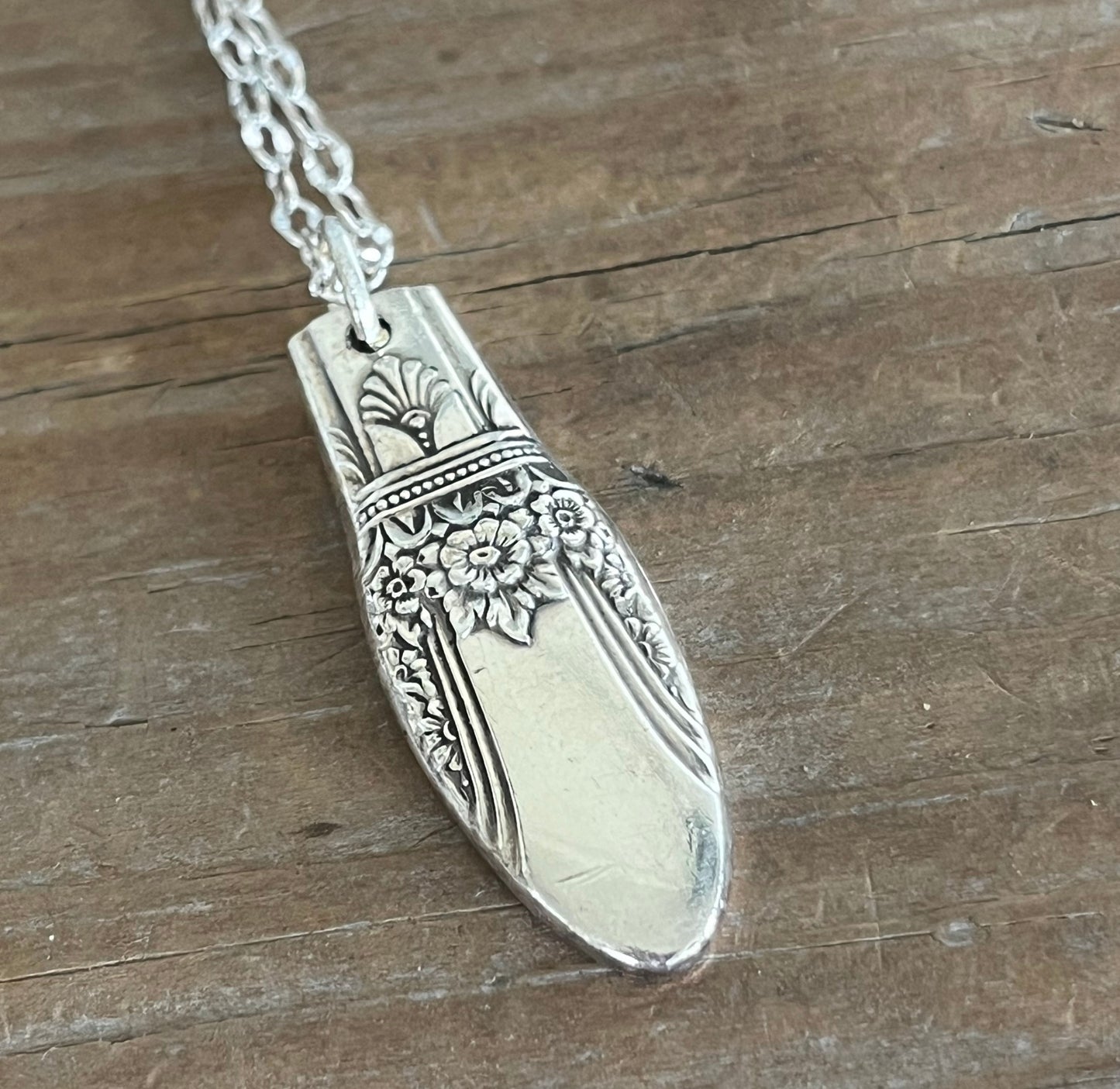 Close up of 1847 Rogers First Love pattern spoon pendant necklace - handcrafted from upcycled vintage silverware - Laughing Frog Studio