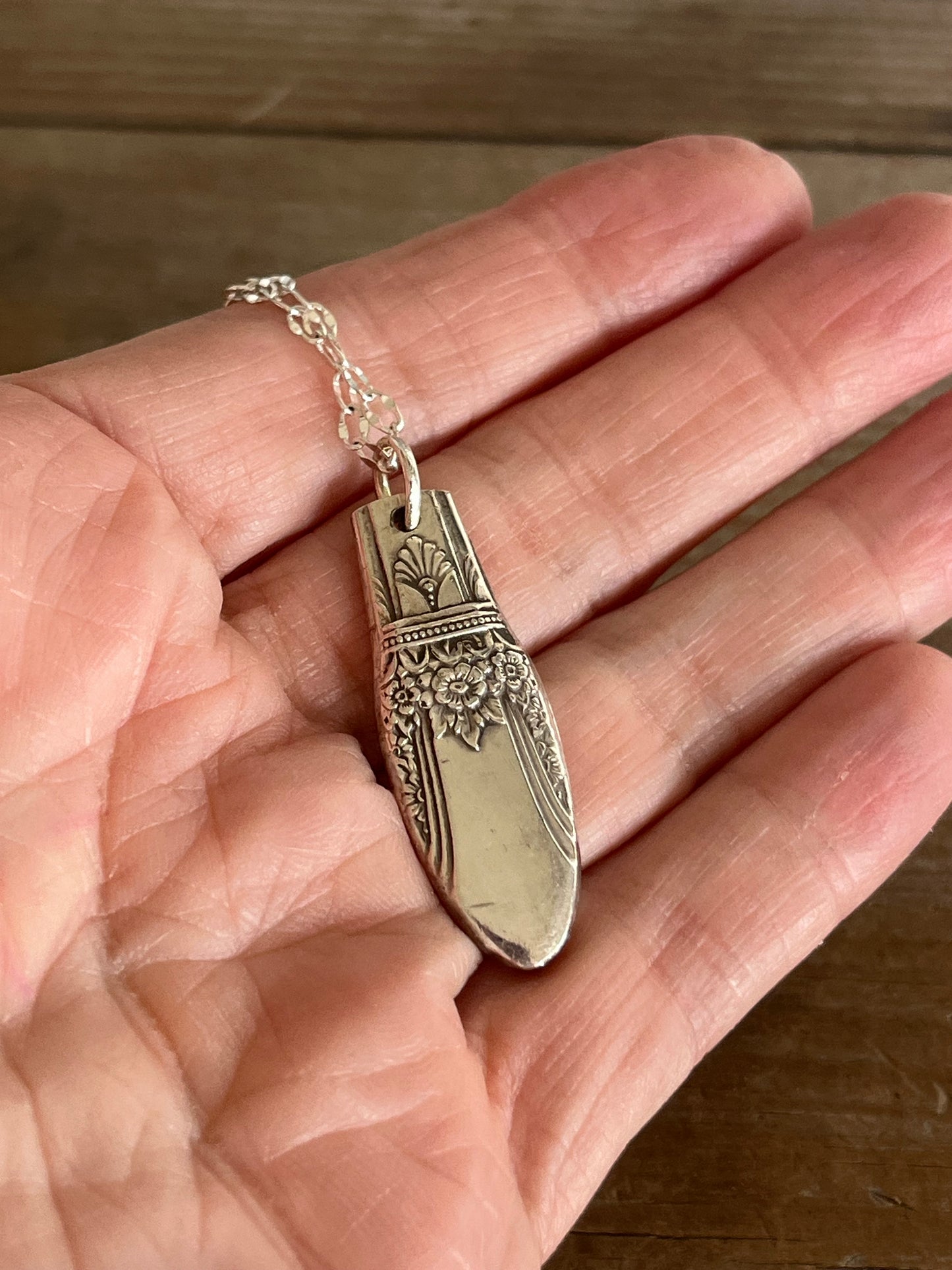 1847 Rogers First Love pattern spoon pendant necklace on chain shown in hand for scale - handcrafted from upcycled vintage silverware - Laughing Frog Studio