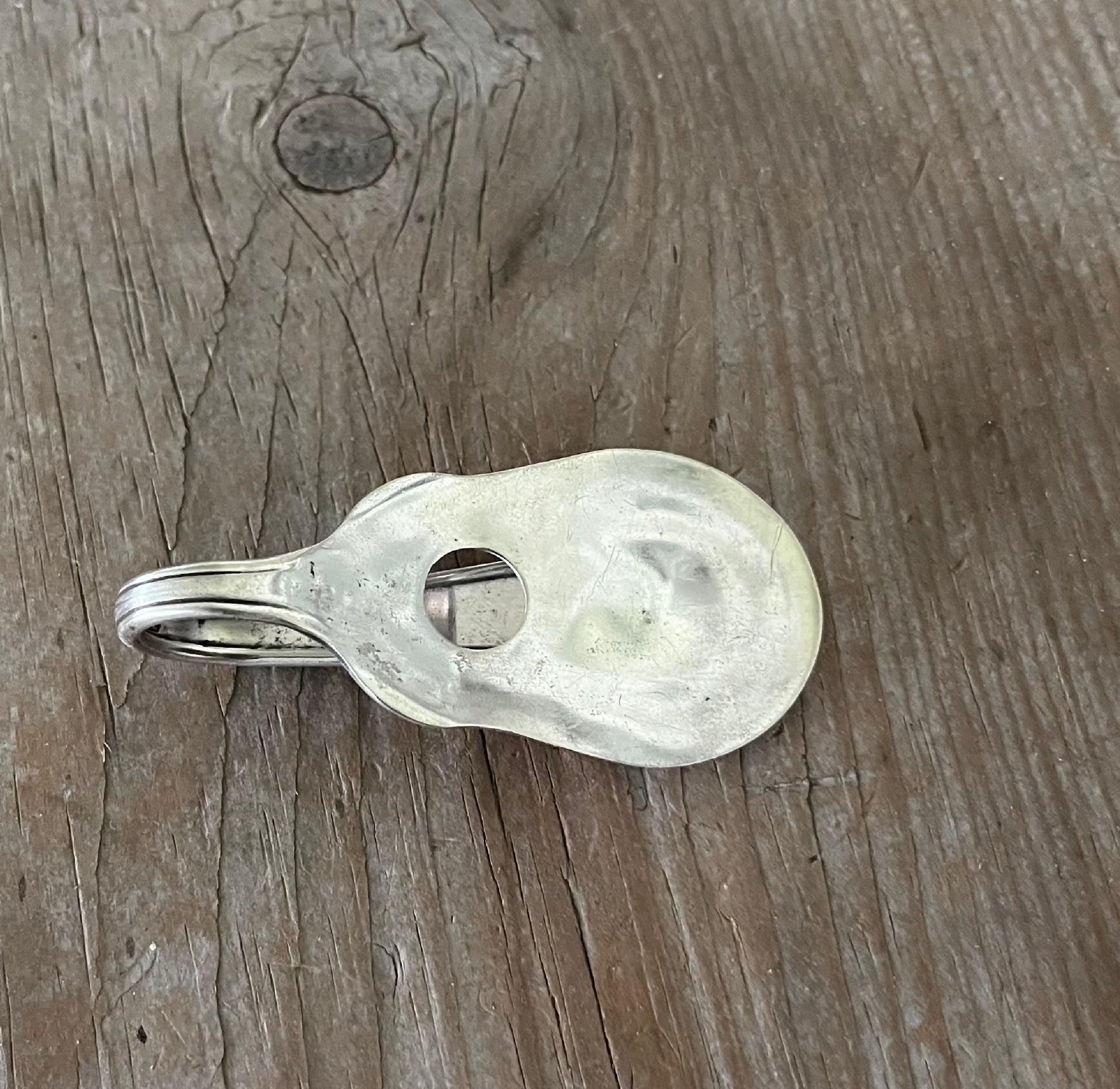 Vintage Vision pattern spoon guitar money clip with sound hole cutout - front view of contoured shape