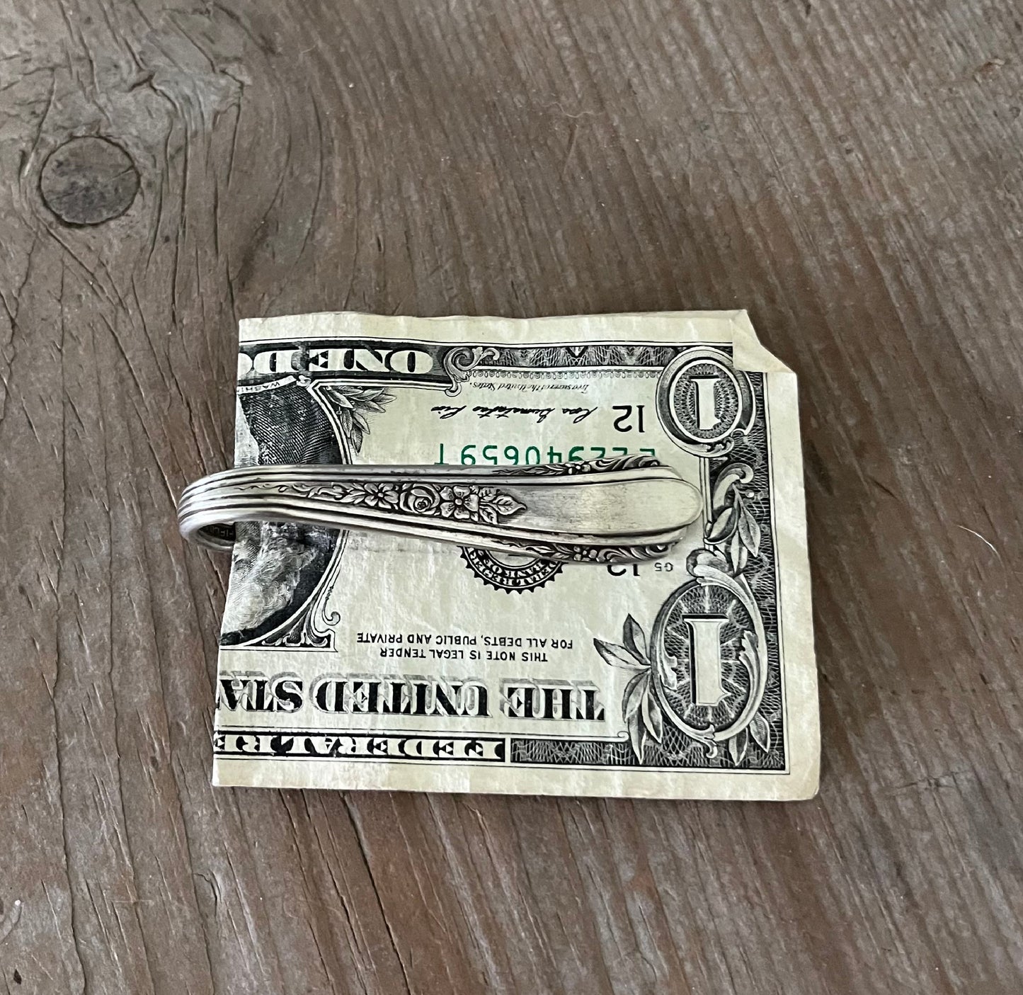 Handcrafted spoon guitar money clip VISION showing floral spray fretboard detail