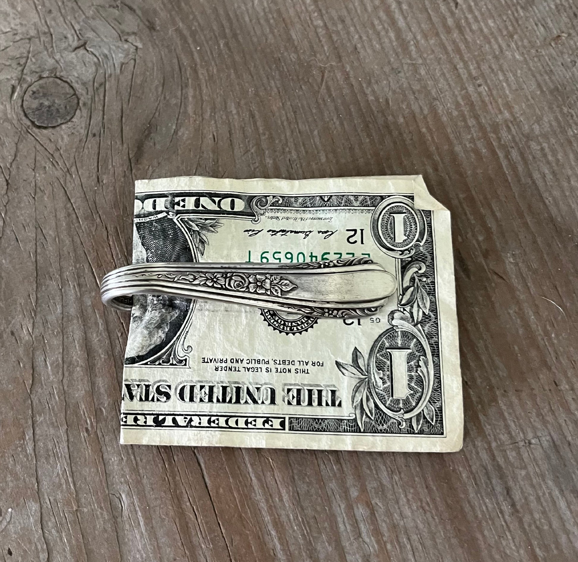 Handcrafted spoon guitar money clip VISION showing floral spray fretboard detail