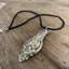 Close-up of Wallace Baroque silverplate ladle pendant showing deep ornate pattern detail, handcrafted vintage silverware necklace