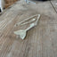 ide view of upcycled spoon mermaid tail necklace showing hand-shaped contoured pendant, artisan ocean jewelry