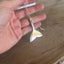 Detail of handcrafted mermaid tail pendant made from vintage silverplate teaspoon, sustainable beach-inspired jewelry