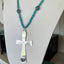 Side view of Artisan spoon cross necklace with turquoise beads and decorative Nepali beads