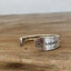 Close-up detail of BADASS hand-stamped spoon cuff bracelet showing Friendship/Medality pattern and vintage silverplate