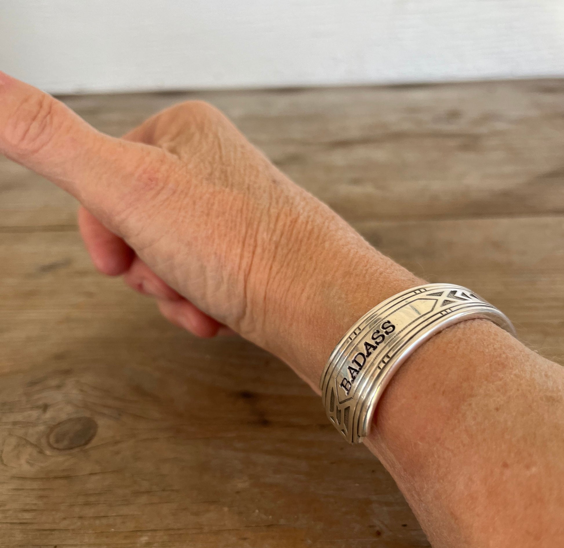 BADASS hand-stamped spoon cuff bracelet shown on model wrist - vintage 1932 Tudor Plate silverplate with empowering message