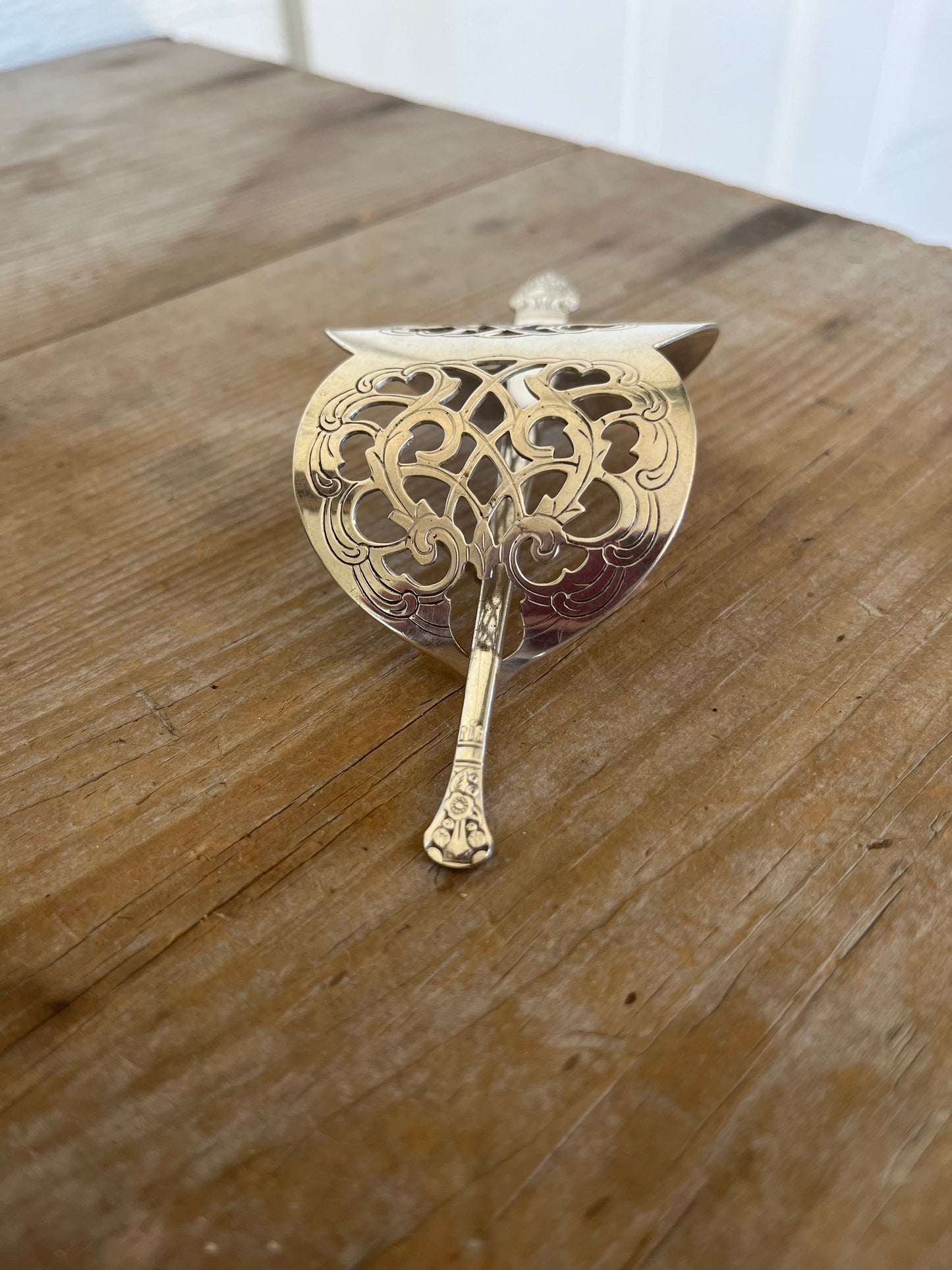 Handcrafted hair barrette from upcycled vintage cake server showing decorative detail