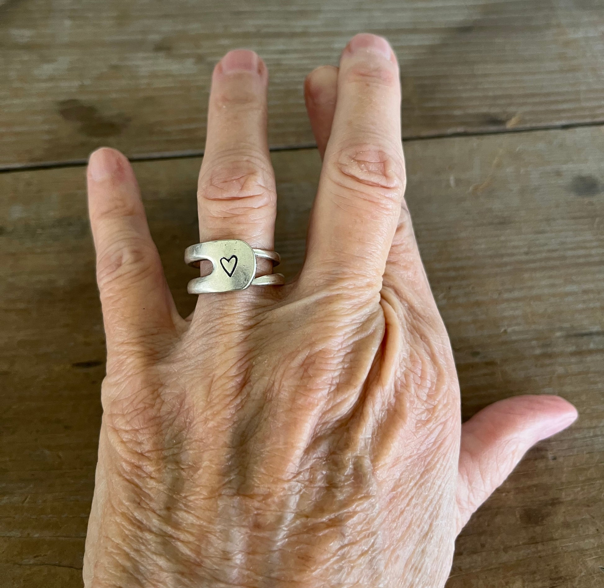Fork tine double band ring with hand-stamped heart on model finger - fork ring - handcrafted from upcycled vintage silverware - Laughing Frog Studio