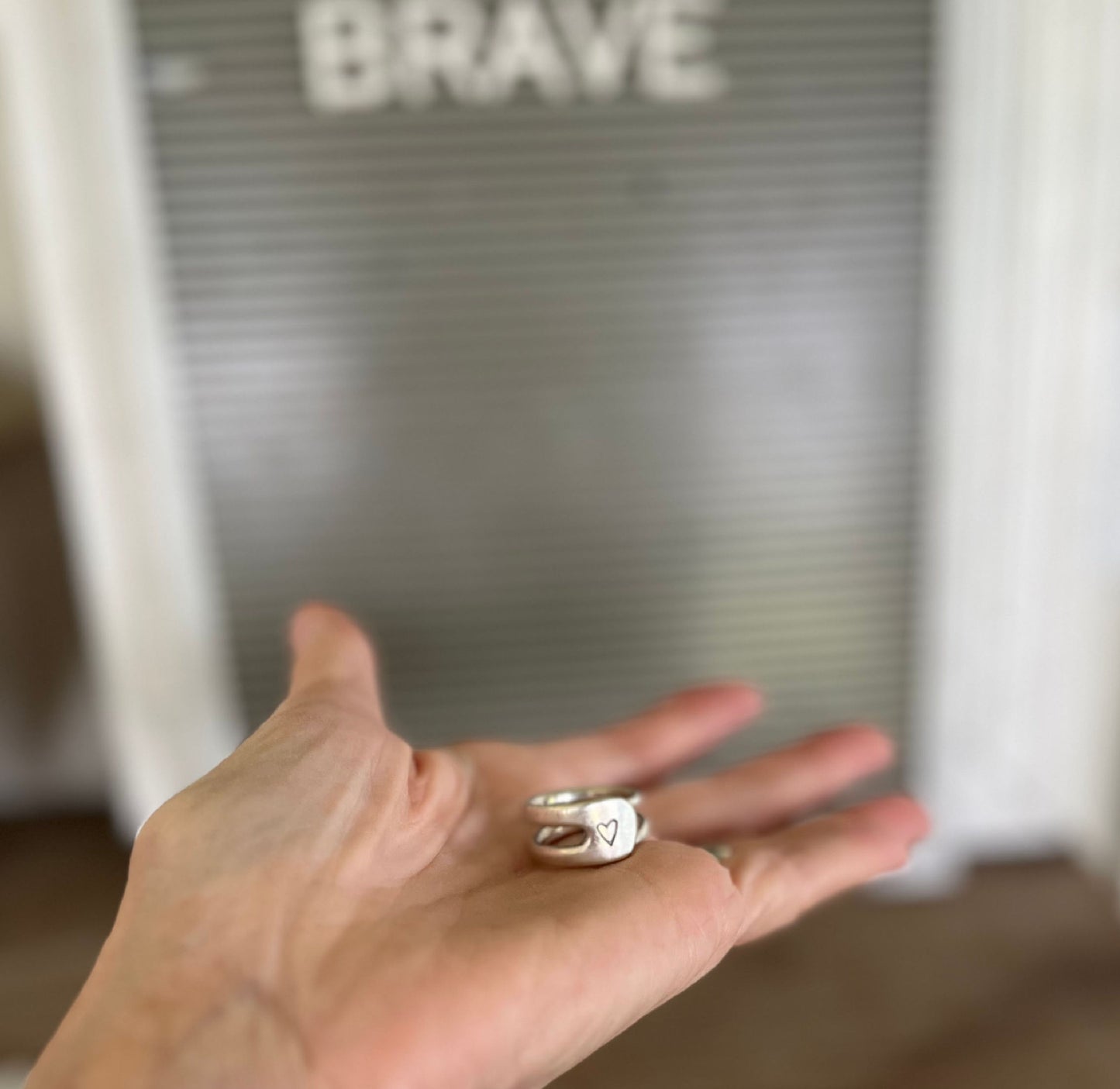 Fork tine double band ring with hand-stamped heart shown in palm of hand - fork ring - handcrafted from upcycled vintage silverware - Laughing Frog Studio
