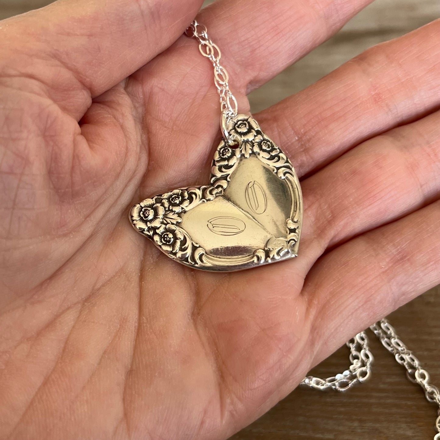 Close-up of soldered heart pendant showing LADY DENSMORE silverware pattern detail