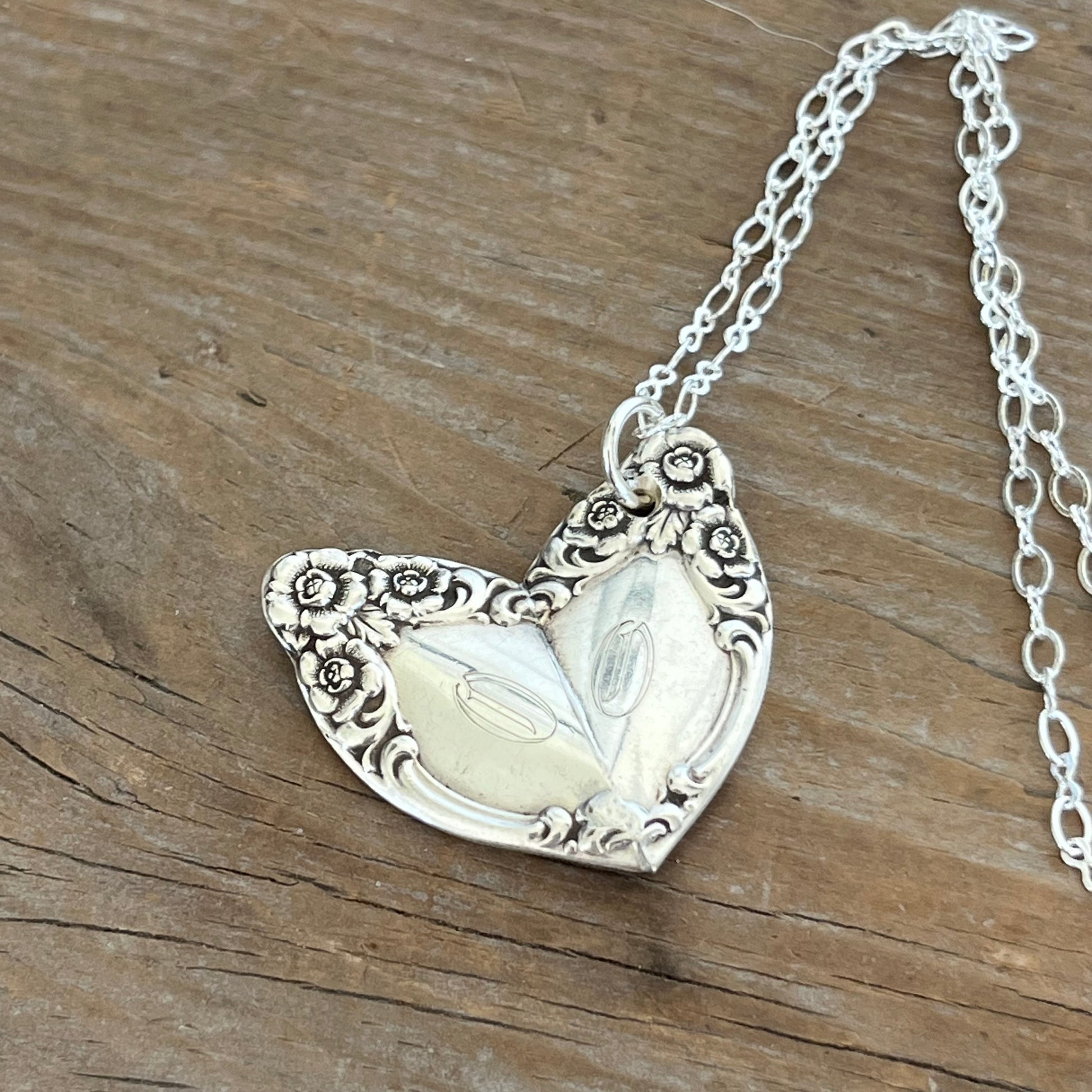 Close up view of upcycled spoon heart necklace showing artisan soldering and gorgeous detail