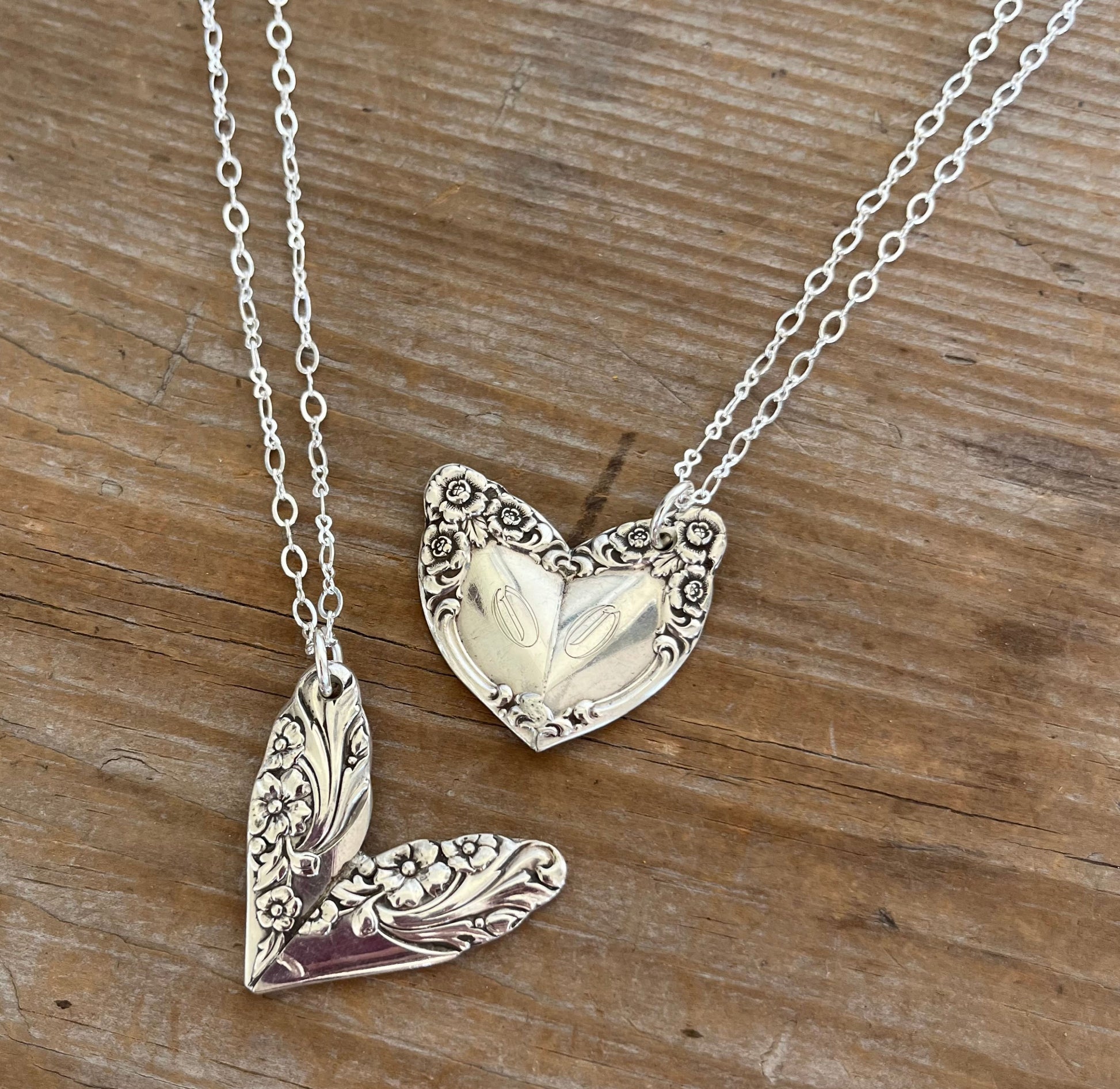 Collection of two silverware heart necklaces displaying two vintage silverware patterns
