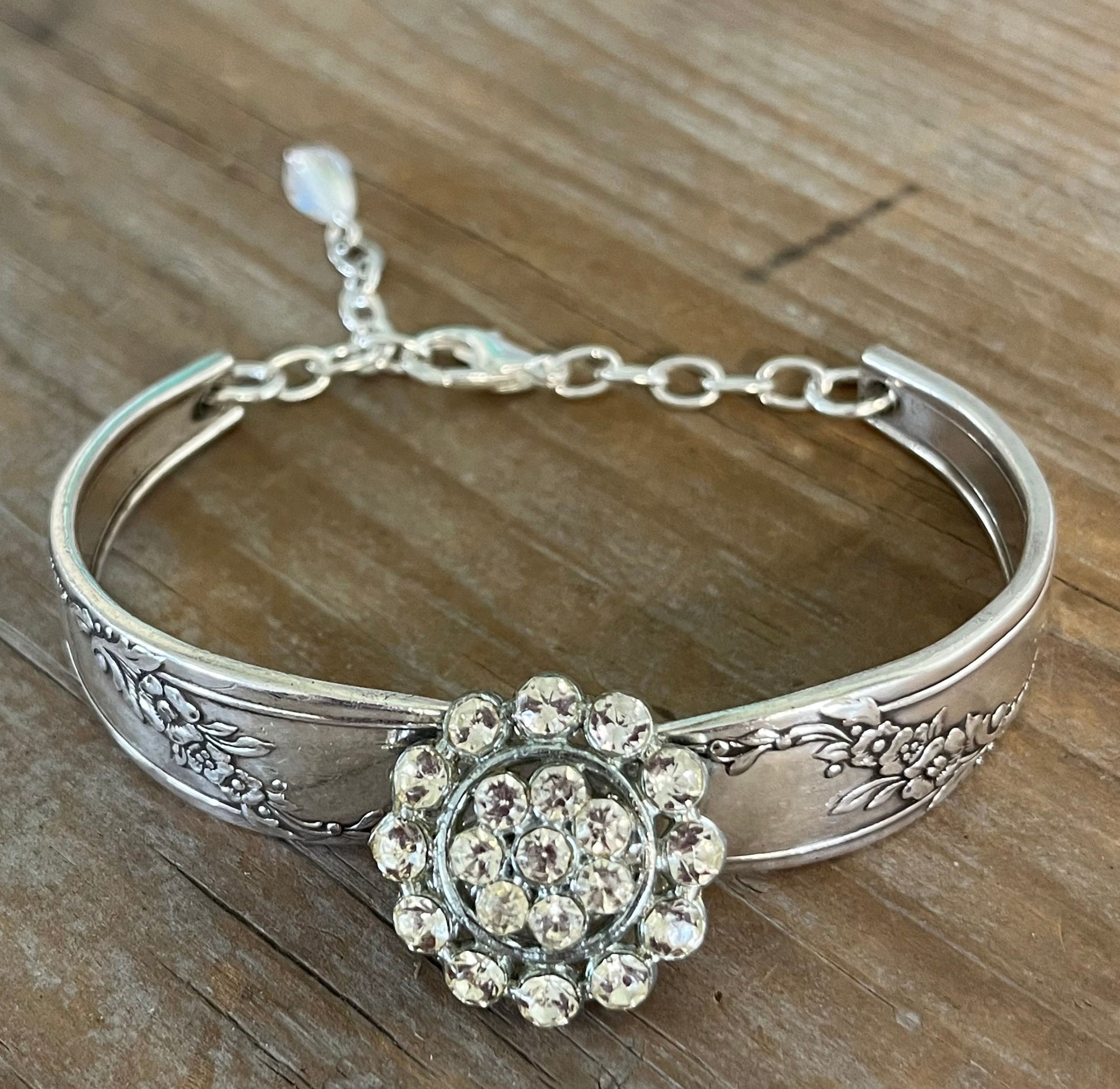 Close-up detail of Queen Bess pattern spoon links with rhinestone button - handmade artisan silverware bracelet