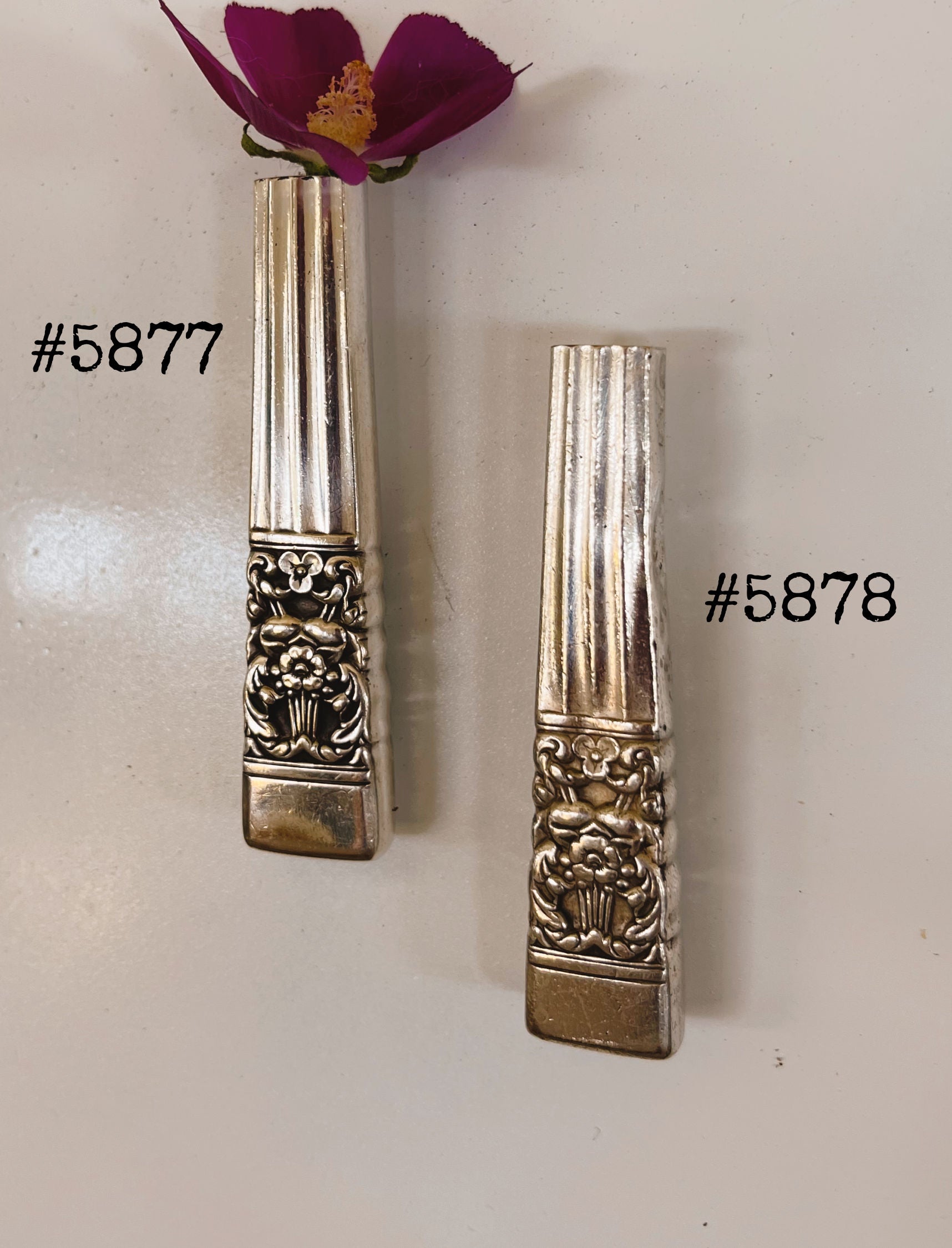 Close-up of handcrafted Coronation pattern upcycled knife vase showing iconic crown motif and polished hollow handle detail