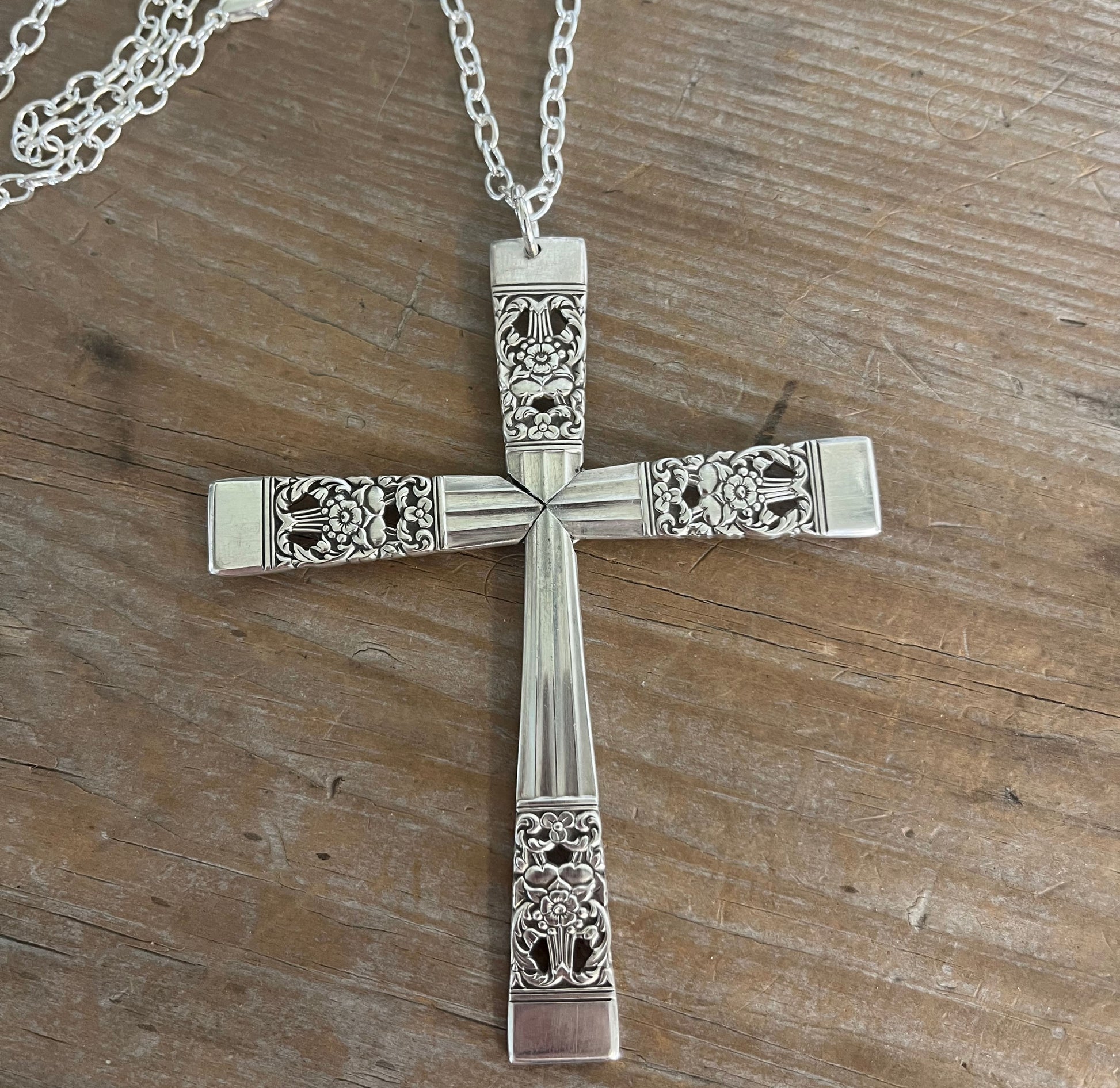 Detail of four-piece construction on Coronation pattern cross pendant made from vintage Community Silverplate spoon handles
