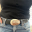 PEACE spoon belt buckle modeled on leather belt showing hand-stamped peace symbol and upcycled silverware craftsmanship, lefty design