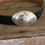 Upcycled silverware belt buckle with star design front view showing vintage casserole spoon craftsmanship, 4.125 x 3 inches
