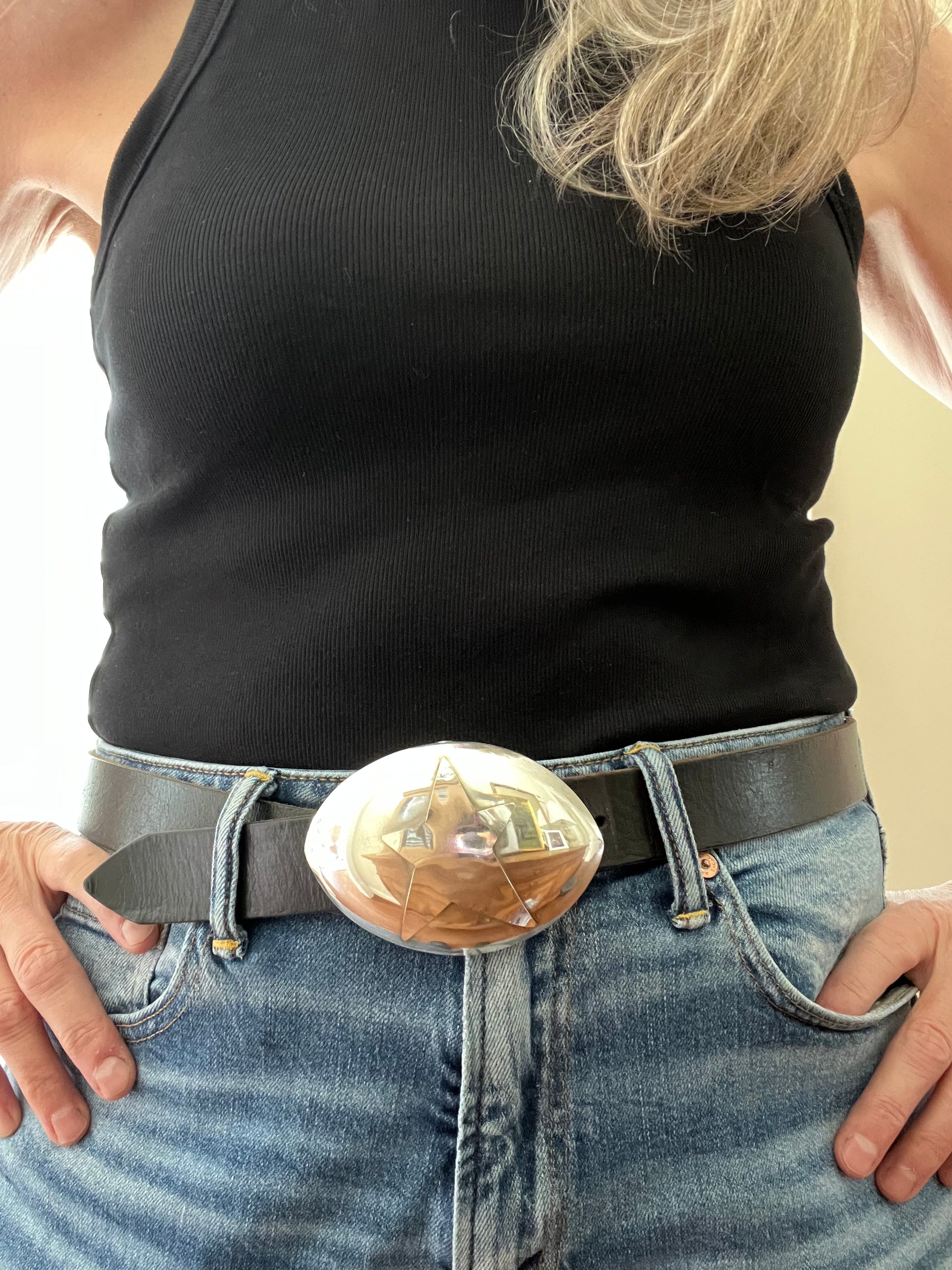 Star spoon belt buckle on model showing hand-forged star pattern on upcycled vintage silverplate, one-of-a-kind lefty design