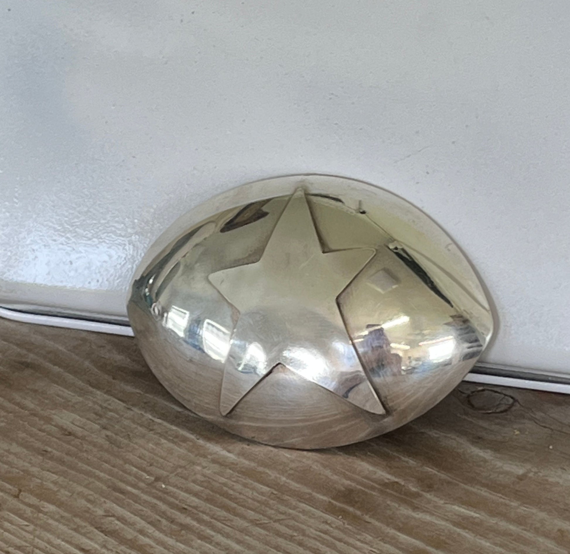 Close-up of stylized star belt buckle showing detailed star pattern on reclaimed vintage spoon, handmade western accessory