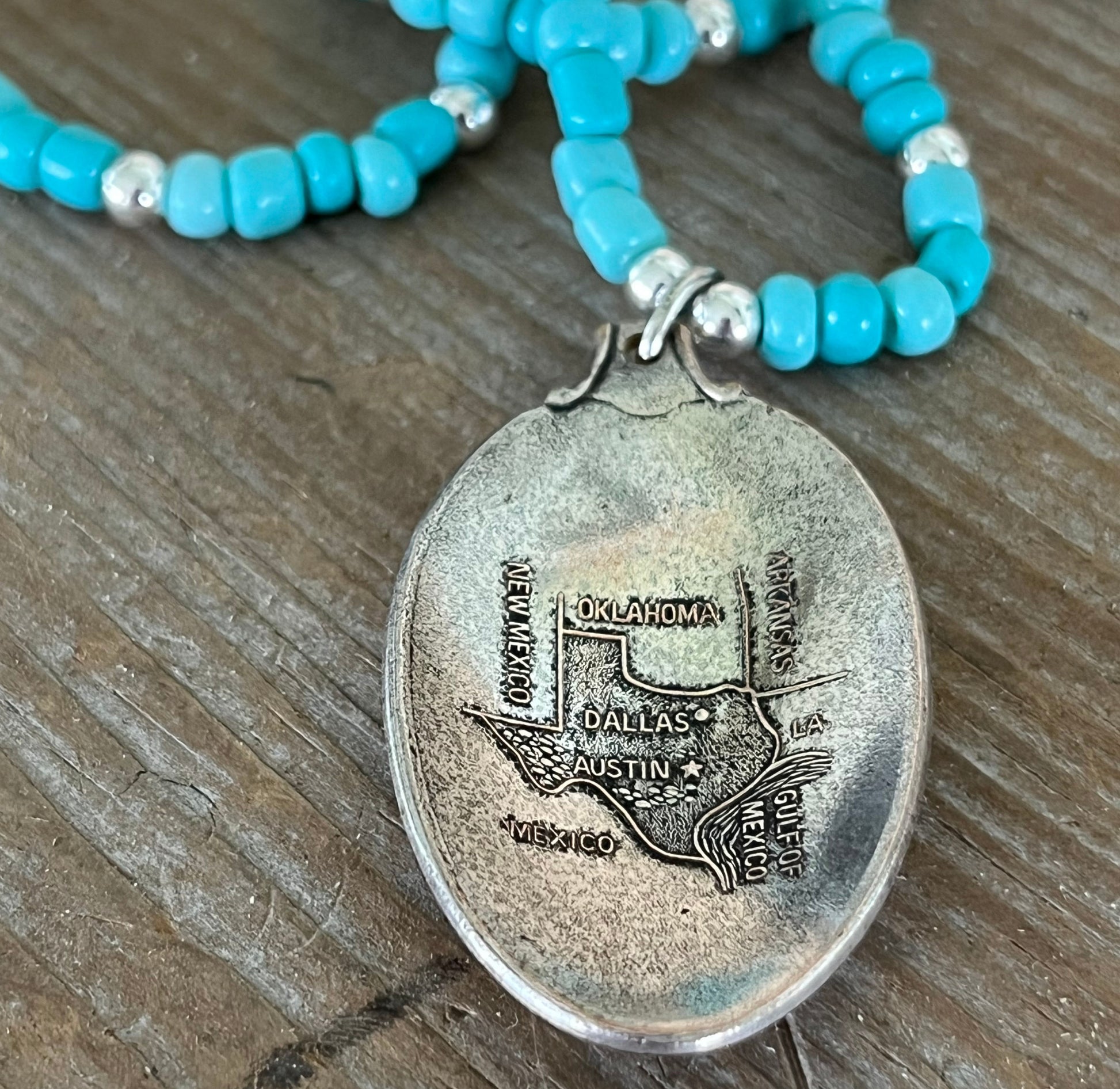 Detail view of Texas Pride pendant necklace featuring Arthur A. Everts Jewelry Co. Texas map on vintage silverware - silverware pendant necklace - handcrafted from upcycled vintage silverware - Laughing Frog Studio