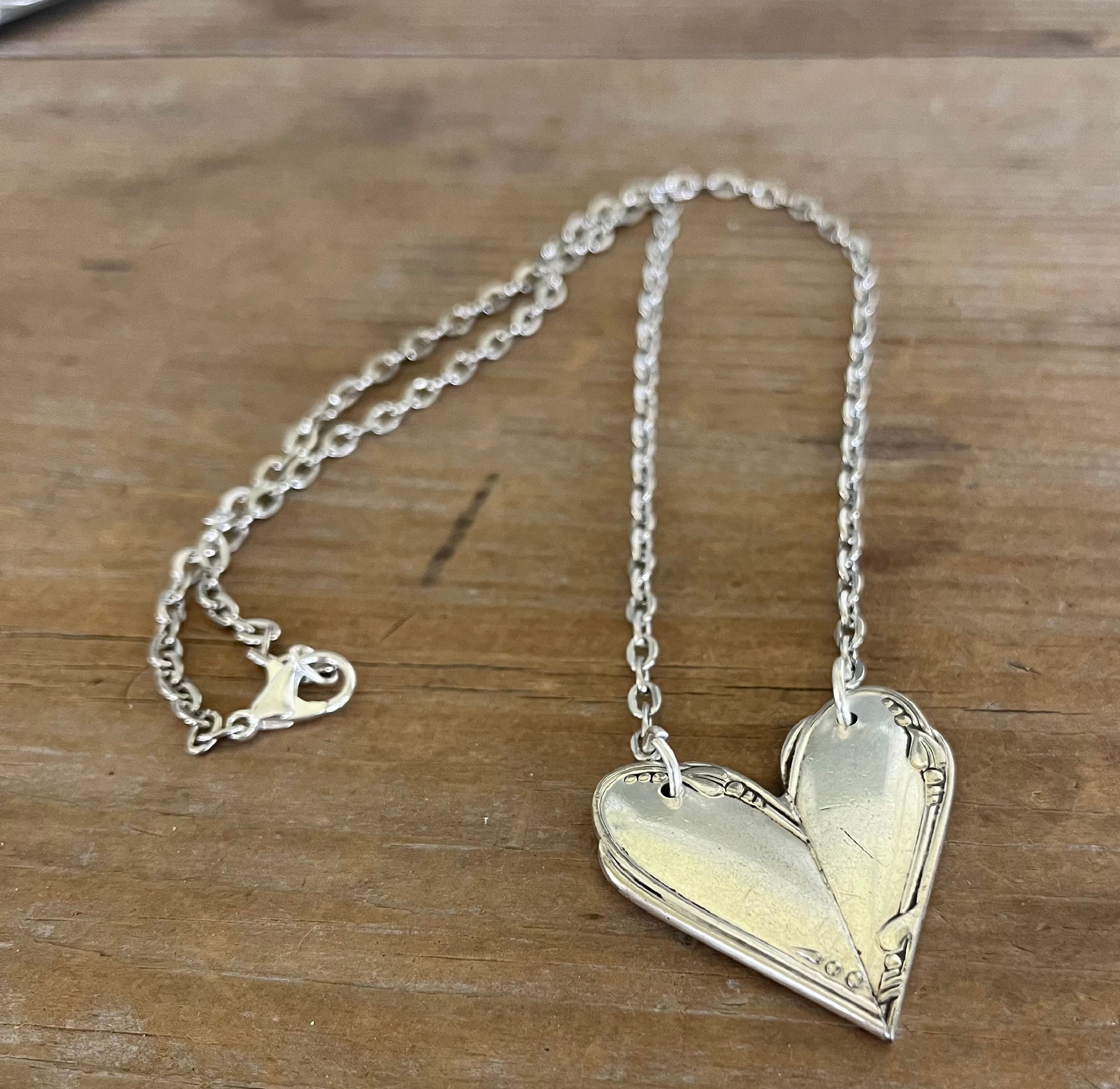 Close up of MEADOWBROOK pattern fork handle heart necklace - Fork Handle Heart Necklace - handcrafted from upcycled vintage silverware - Laughing Frog Studio