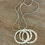 Close-up of hand-stamping on kinetic movement rings artisan spoon necklace - artisan silverware statement necklace - handcrafted from upcycled vintage silverware - Laughing Frog Studio