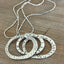 Close-up of artisan spoon necklace with moving rings - artisan silverware statement necklace - handcrafted from upcycled vintage silverware - Laughing Frog Studio