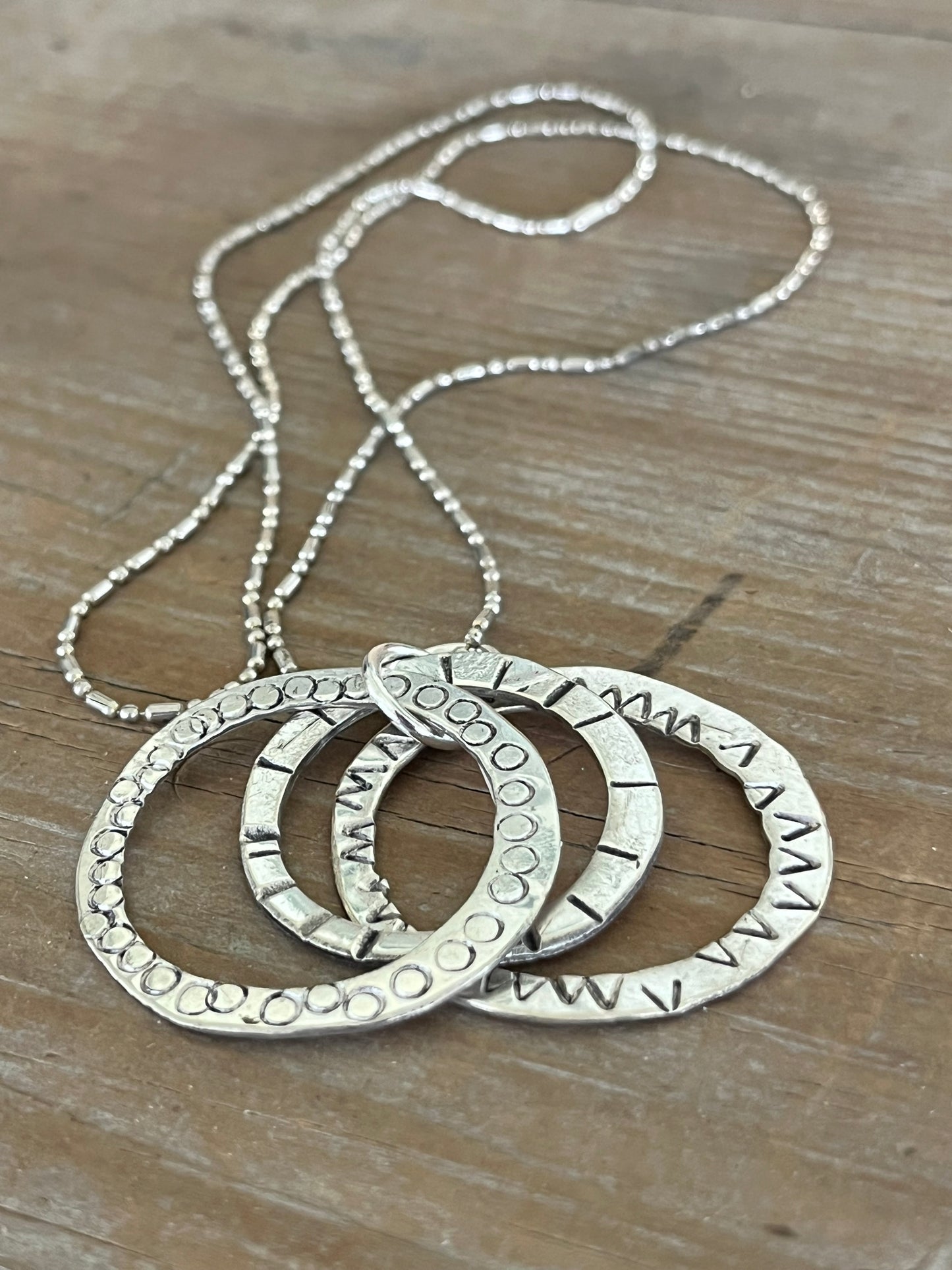 Close-up of artisan spoon necklace with moving rings - artisan silverware statement necklace - handcrafted from upcycled vintage silverware - Laughing Frog Studio