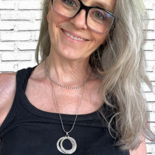 Hand-stamped kinetic movement rings artisan spoon necklace on model - artisan silverware statement necklace - handcrafted from upcycled vintage silverware - Laughing Frog Studio