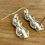 Close-up detail of elegant Interlude pattern spoon handle earrings, upcycled vintage silverware, 2.375 inches long
