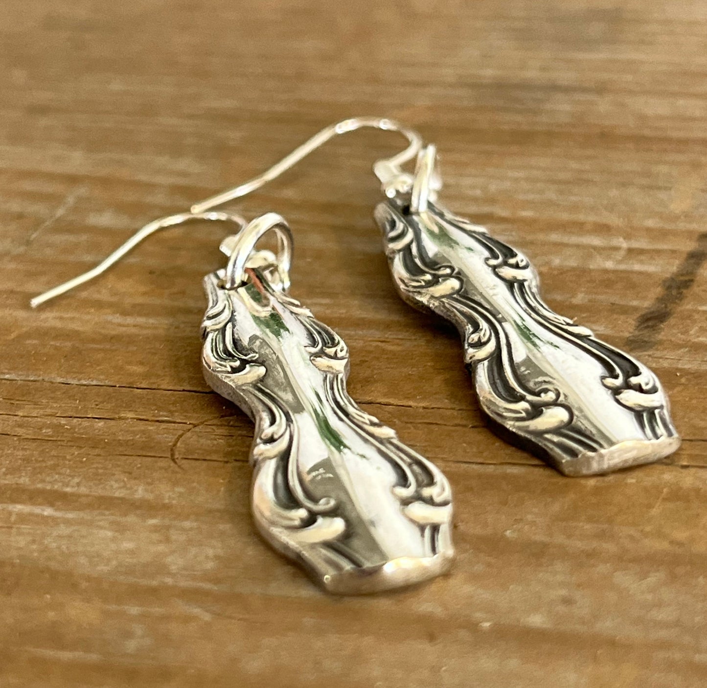 Close-up detail of elegant Interlude pattern spoon handle earrings, upcycled vintage silverware, 2.375 inches long