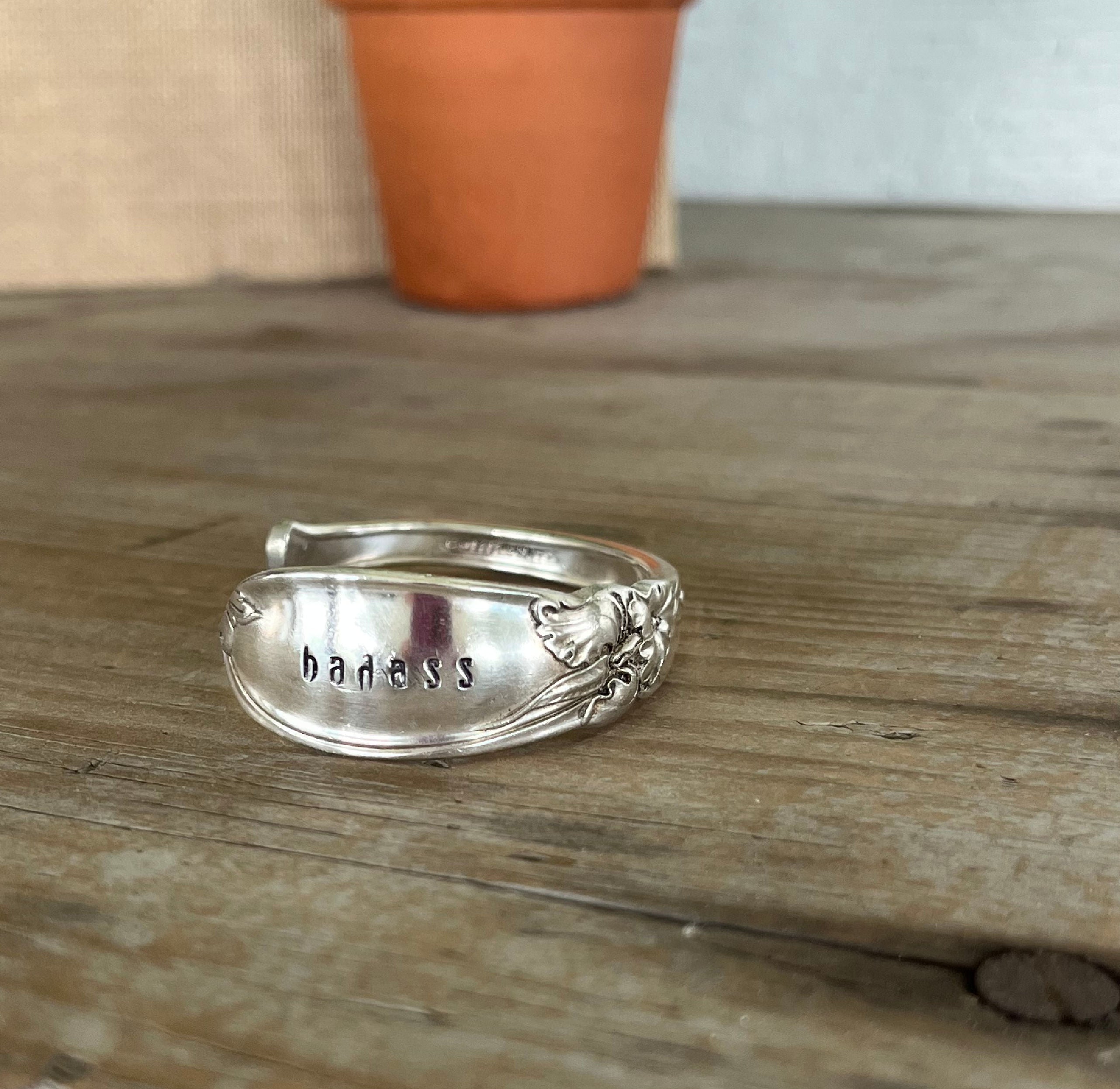 Close-up detail of BADASS hand-stamped spoon cuff bracelet showing flowing White Orchid pattern and vintage silverplate