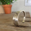 Standing view of BADASS hand-stamped vintage Community White Orchid silverplate spoon cuff bracelet - hand-stamped spoon cuff bracelet - handcrafted from upcycled vintage silverware - Laughing Frog Studio