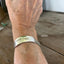 FUCKITY FUCK FUCK hand-stamped message on vintage silverplate spoon cuff bracelet worn on model wrist - handcrafted from upcycled vintage silverware - Laughing Frog Studio