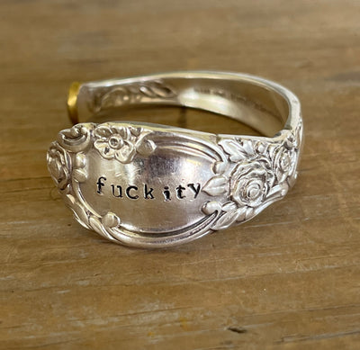 Silver spoon cuff bracelet with floral rose pattern stamped fuckity on wood surface - Oneida Ballad cuff bracelet - handcrafted from upcycled vintage silverware - Laughing Frog Studio
