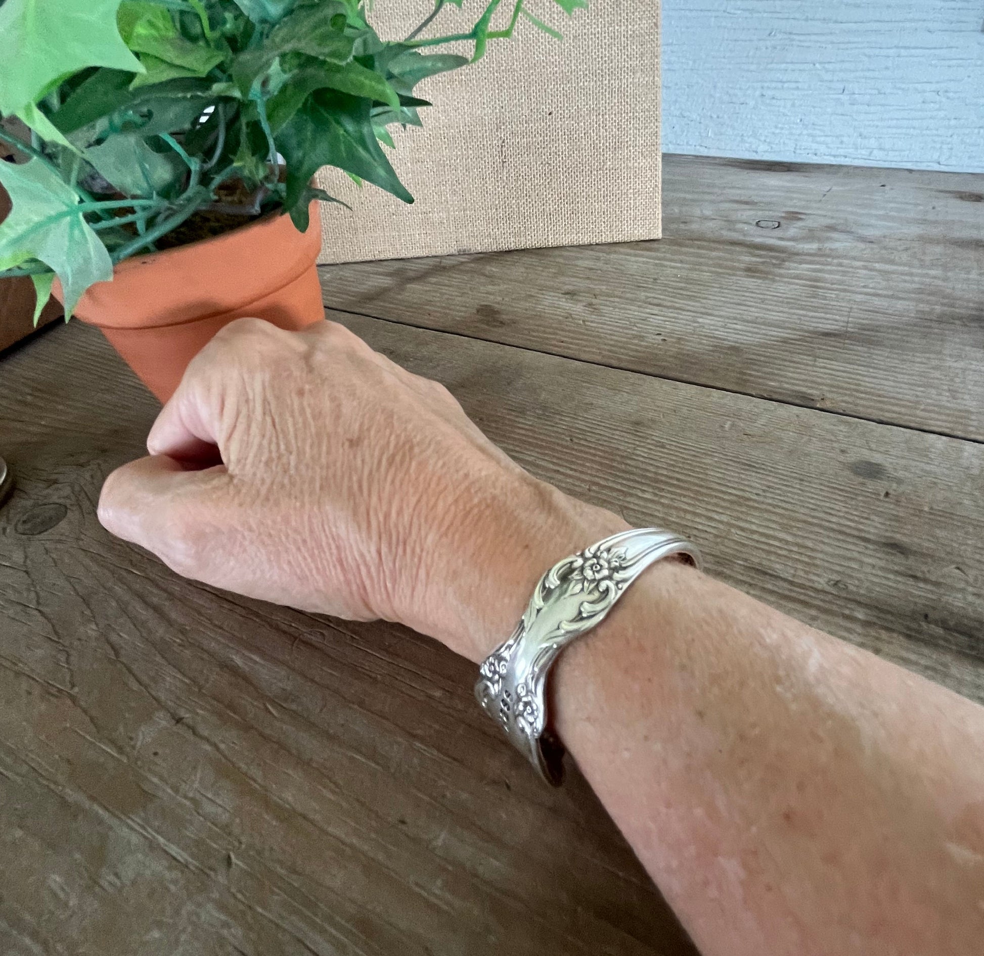 BADASS hand-stamped spoon cuff bracelet shown on model wrist - 1959 William Rogers Grand Elegance - upcycled vintage silverware - Laughing Frog Studio