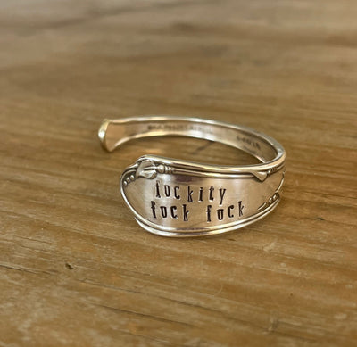 FUCKITY FUCK FUCK hand-stamped spoon cuff bracelet with modern font front view - 1936 W.A. Rogers Meadowbrook - upcycled vintage silverware - Laughing Frog Studio