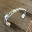 Top view of FUCKITY FUCK FUCK hand-stamped spoon cuff bracelet with modern font - 1936 W.A. Rogers Meadowbrook - upcycled vintage silverware - Laughing Frog Studio