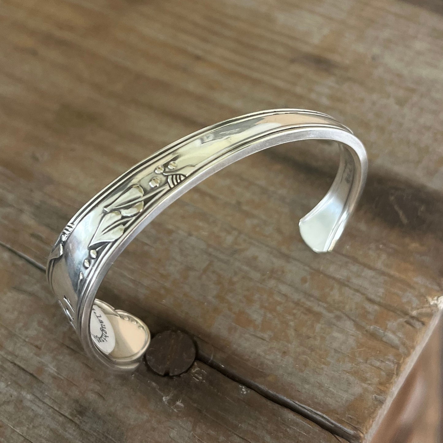 Top view of FUCKITY FUCK FUCK hand-stamped spoon cuff bracelet with modern font - 1936 W.A. Rogers Meadowbrook - upcycled vintage silverware - Laughing Frog Studio