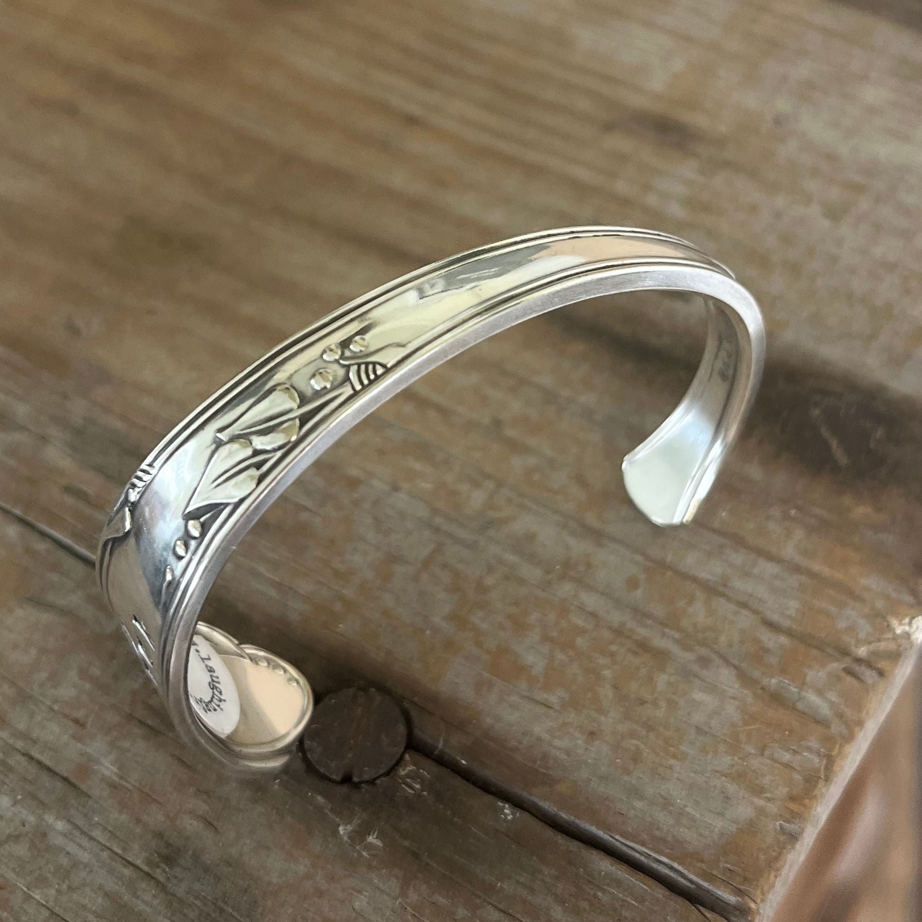 Top view of FUCKITY FUCK FUCK hand-stamped spoon cuff bracelet with modern font - 1936 W.A. Rogers Meadowbrook - upcycled vintage silverware - Laughing Frog Studio